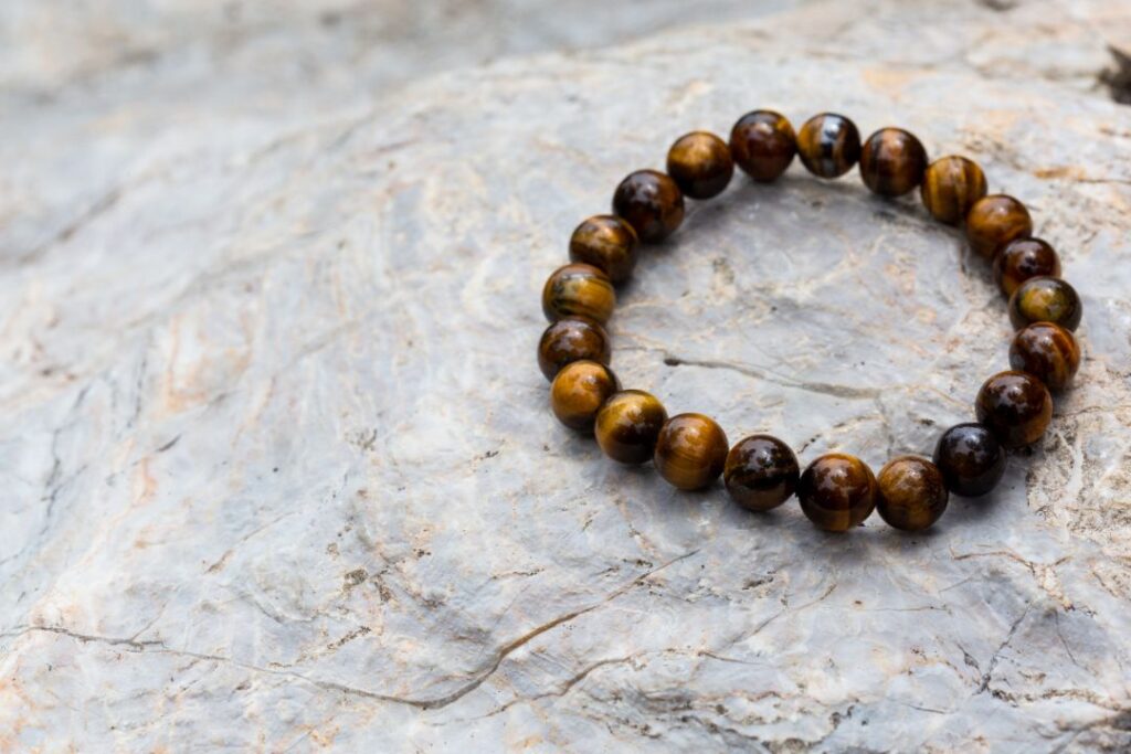 tiger's eye bracelet on top of a rock