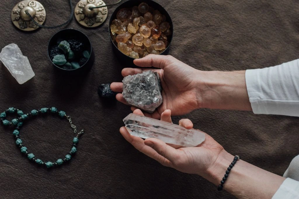 A person holding different crystals