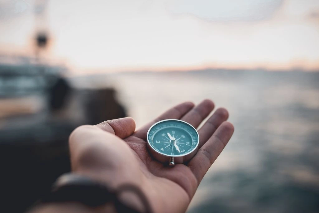 A person holding a compass