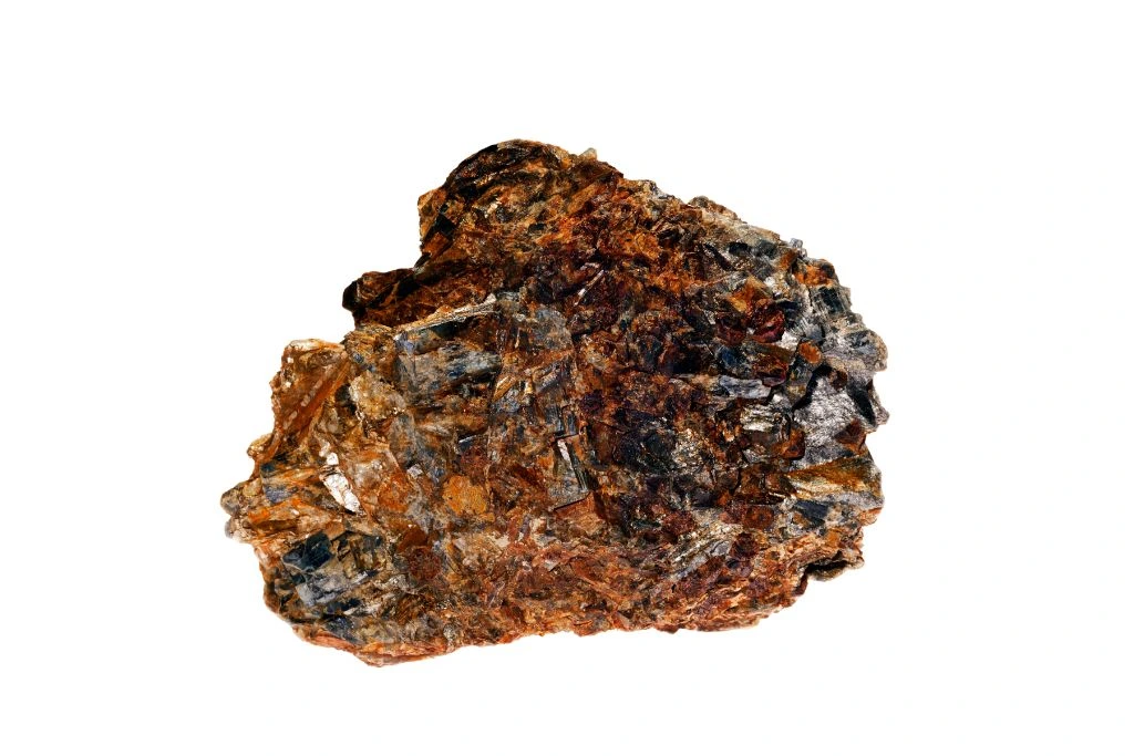 A raw orange kyanite on a white background