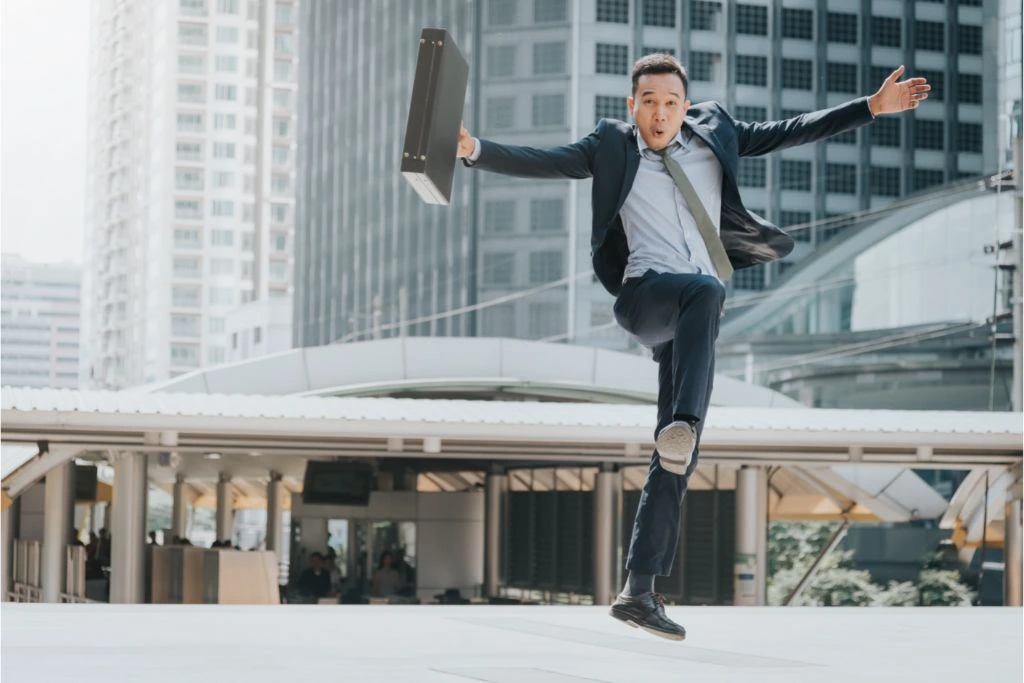 Businessman in a suit jumping with joy