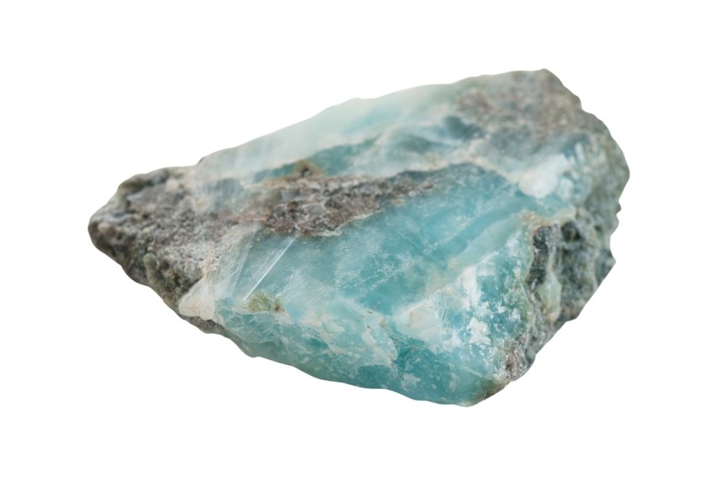 A raw larimar crystal on a white background