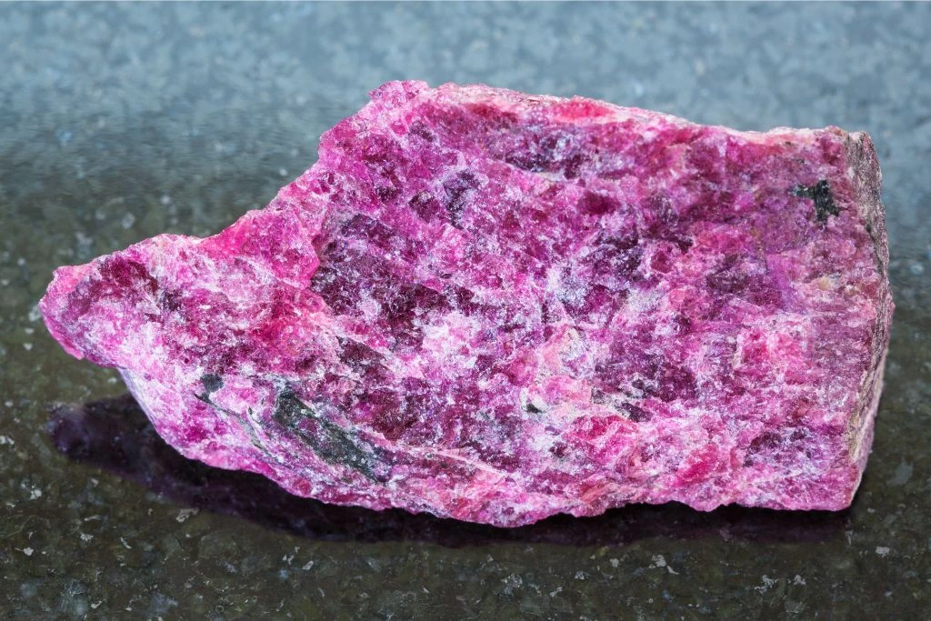 Raw Eudalite on a granite background