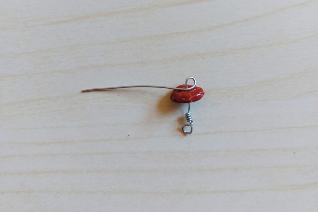 in the middle of the gemstone, a loop copper wire is twisted and locked