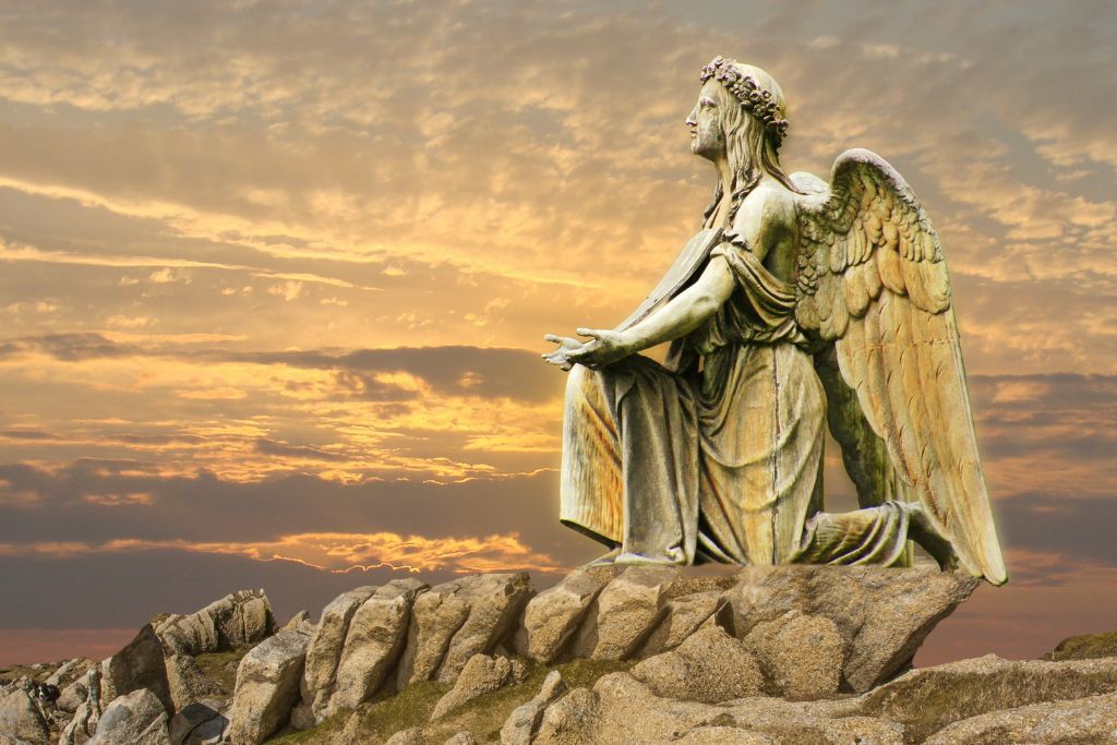 An angel statue that is kneeling