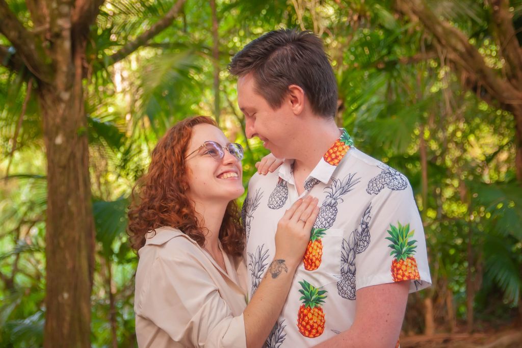 A happy couple is strolling in a garden forest.