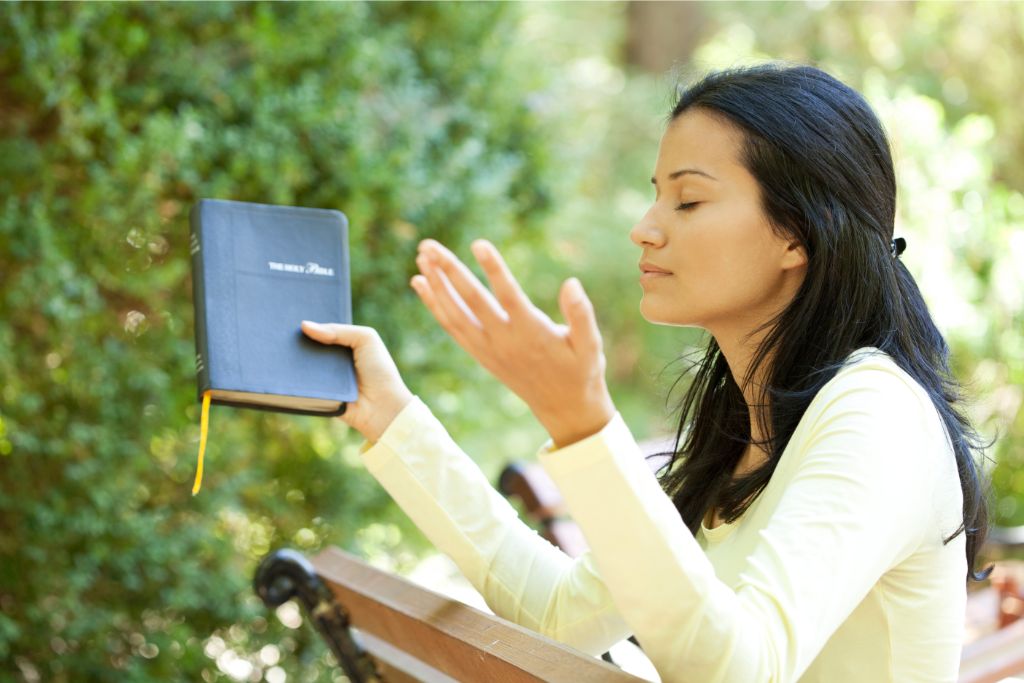 A woman is praying in nature