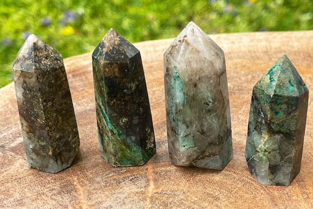 Quantum Quattro Crystal Wands on a wooden trunk. Source: Etsy | HandyNat