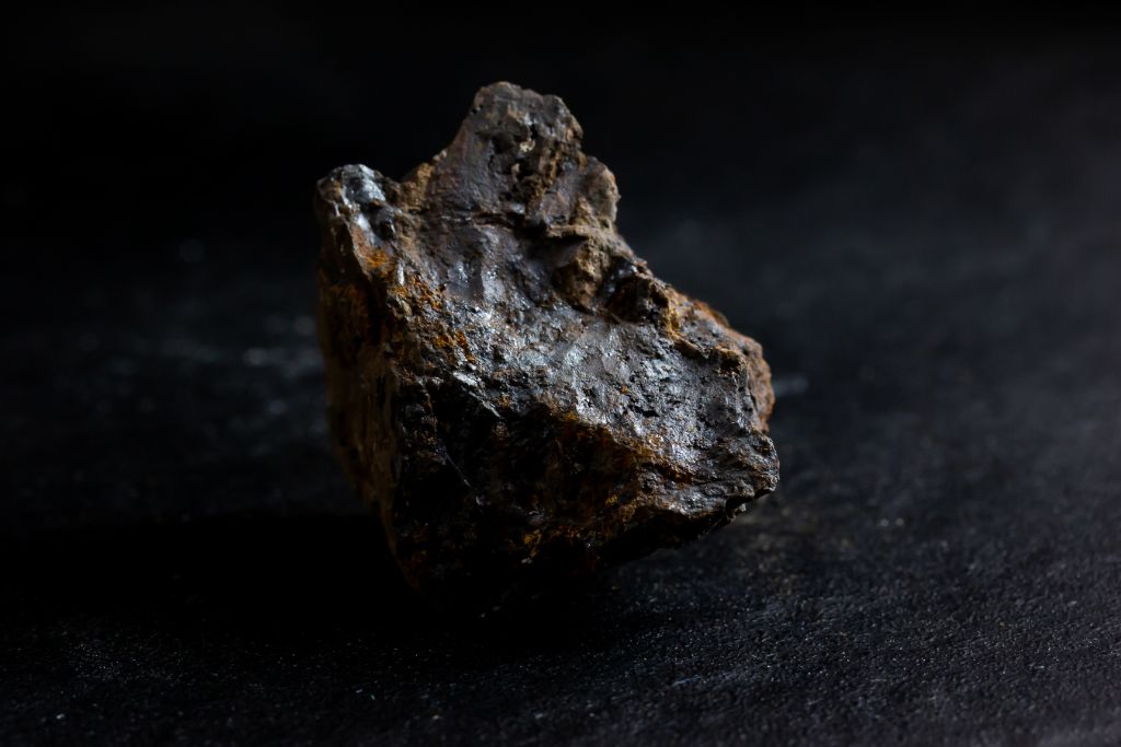 A Pyrolusite crystal on a dark background
