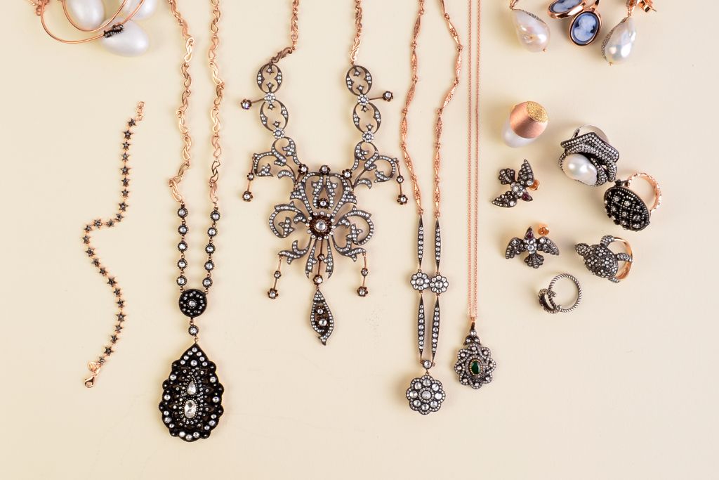 assorted diamond jewelry on cream background