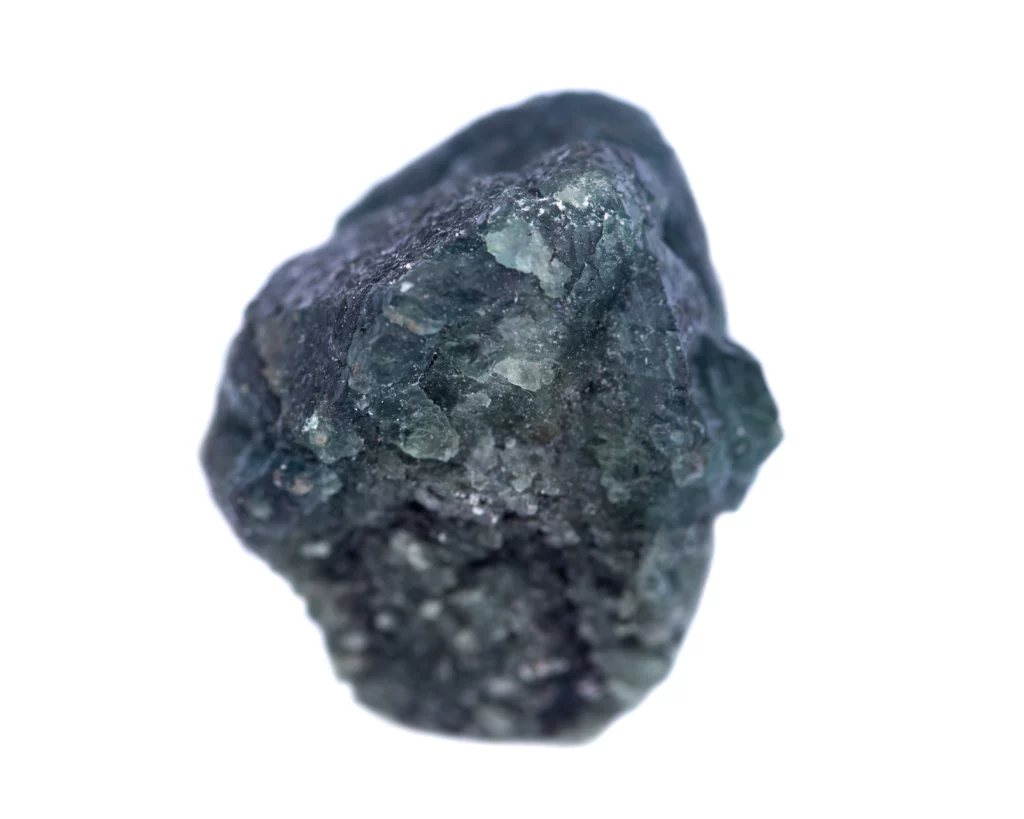 Unpolished Alexandrite in a white background