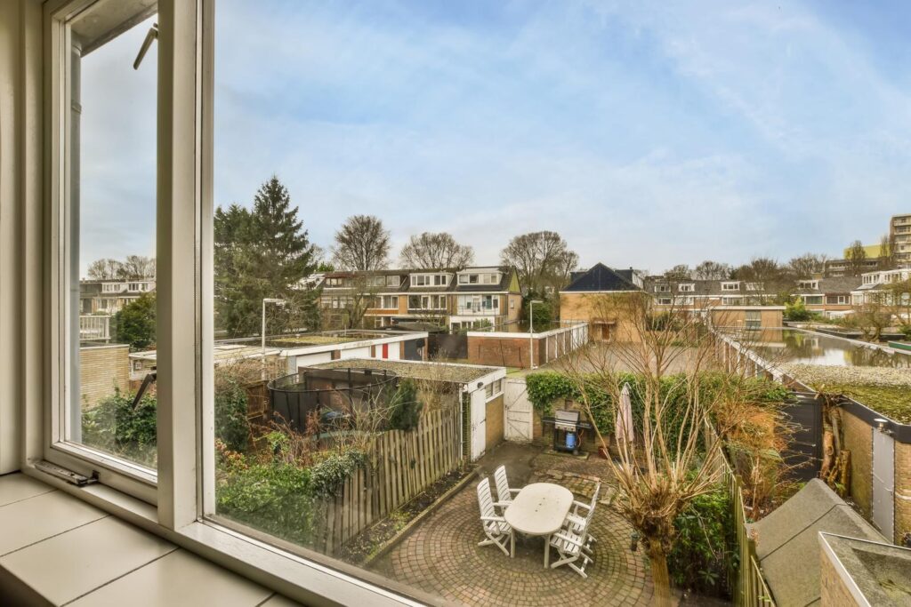 View from the window to the backyard with a sitting area of a modern house