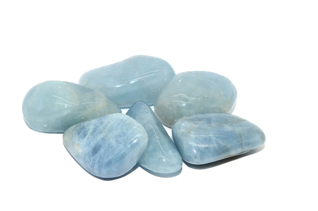 Tumbled Aquamarine stones on a white background