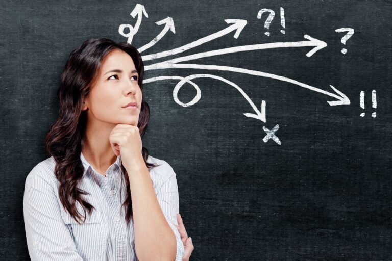 woman thinking in front of a blackboard