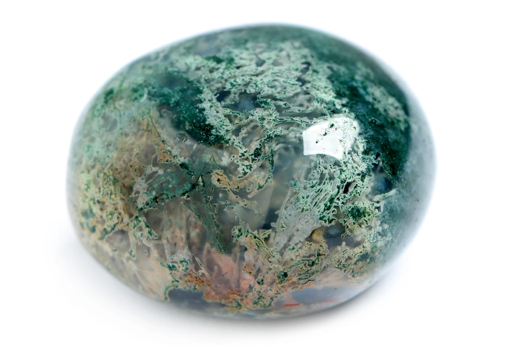 A moss agate on a white background