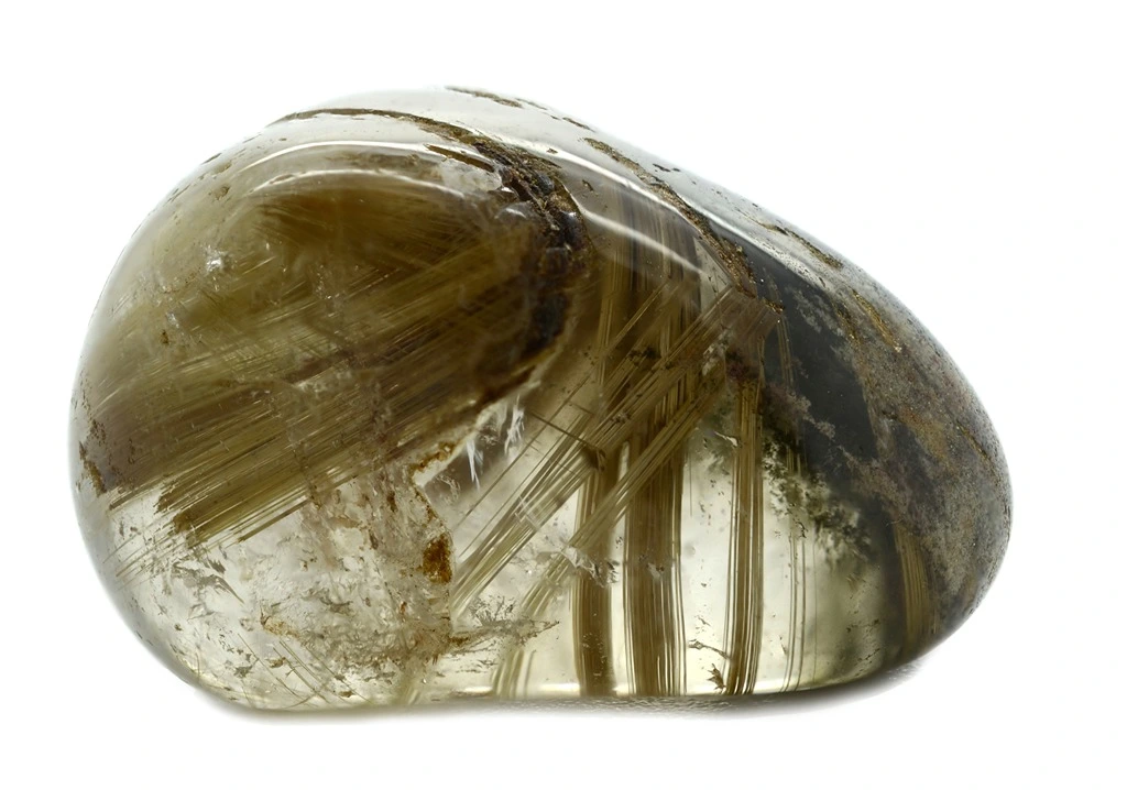 polished rutilated quartz on a white background