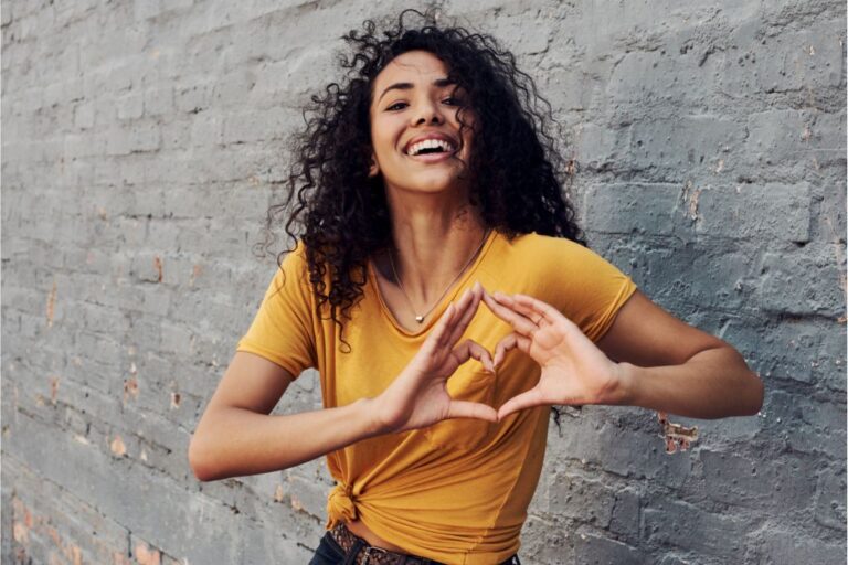 Girl showing a heart sign by her hands