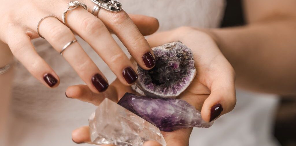 woman holding assorted crystals