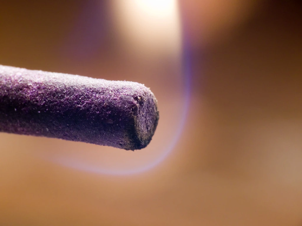 lavender incense stick on a white background