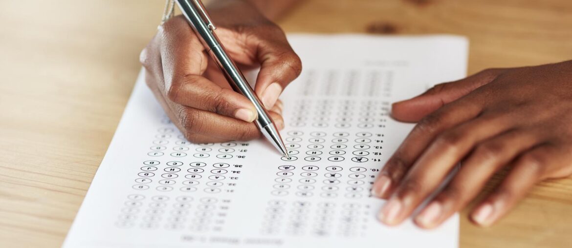 Taking a test. Shot of a person filling in an answer sheet for a test.