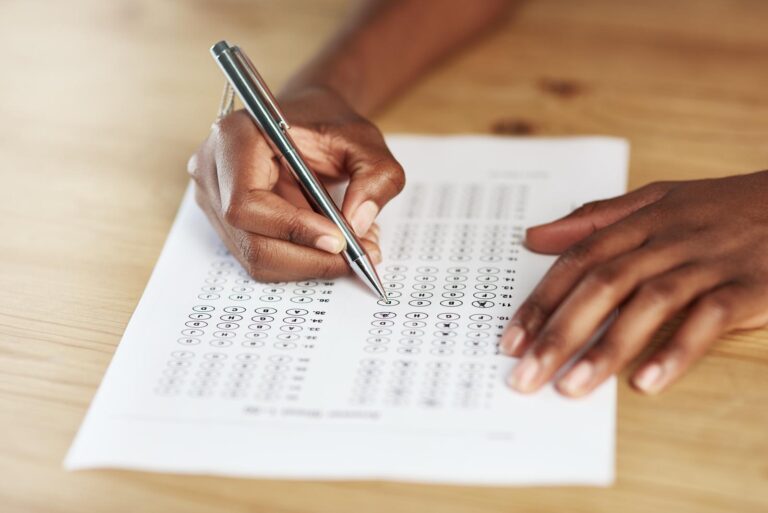 Taking a test. Shot of a person filling in an answer sheet for a test.