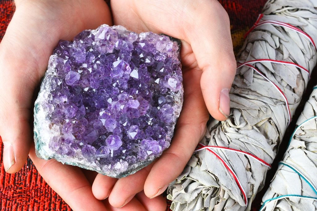 woman holding amethyst crystal 