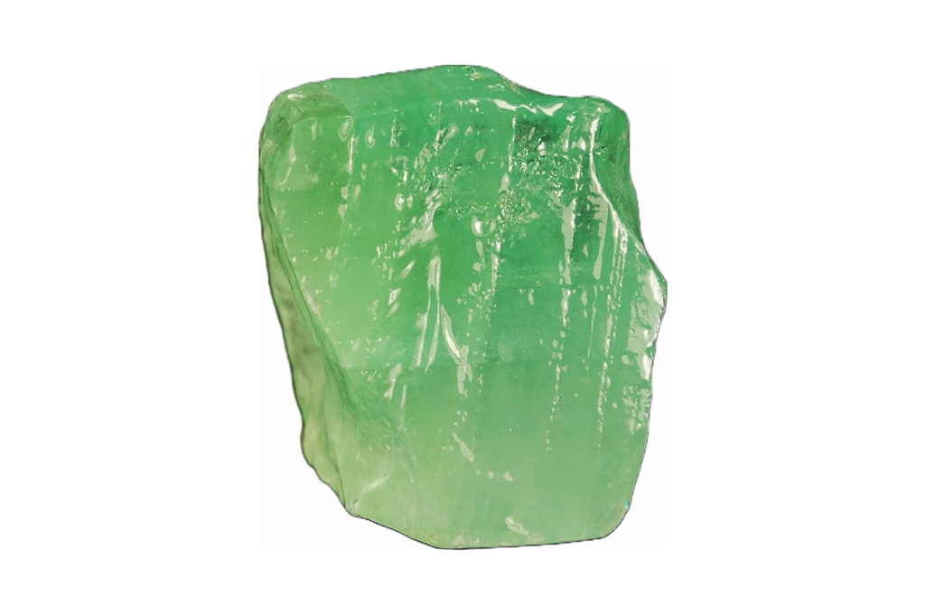 Green calcite crystal on a white background