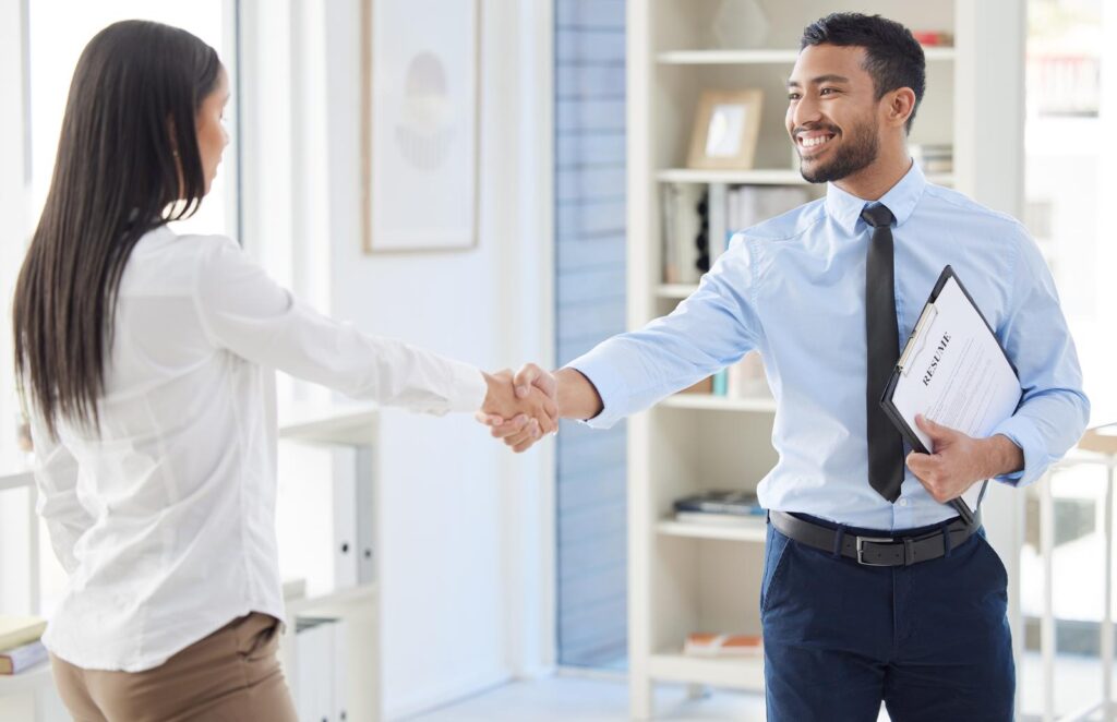 Employee shaking hand with his boss as she got promoted