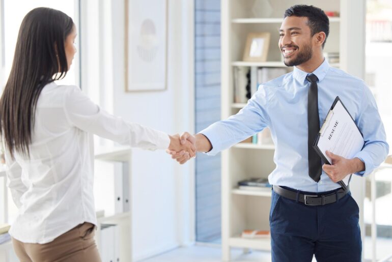 Employee shaking hand with his boss as she got promoted