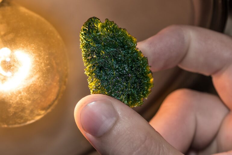 modavite stone held by fingers