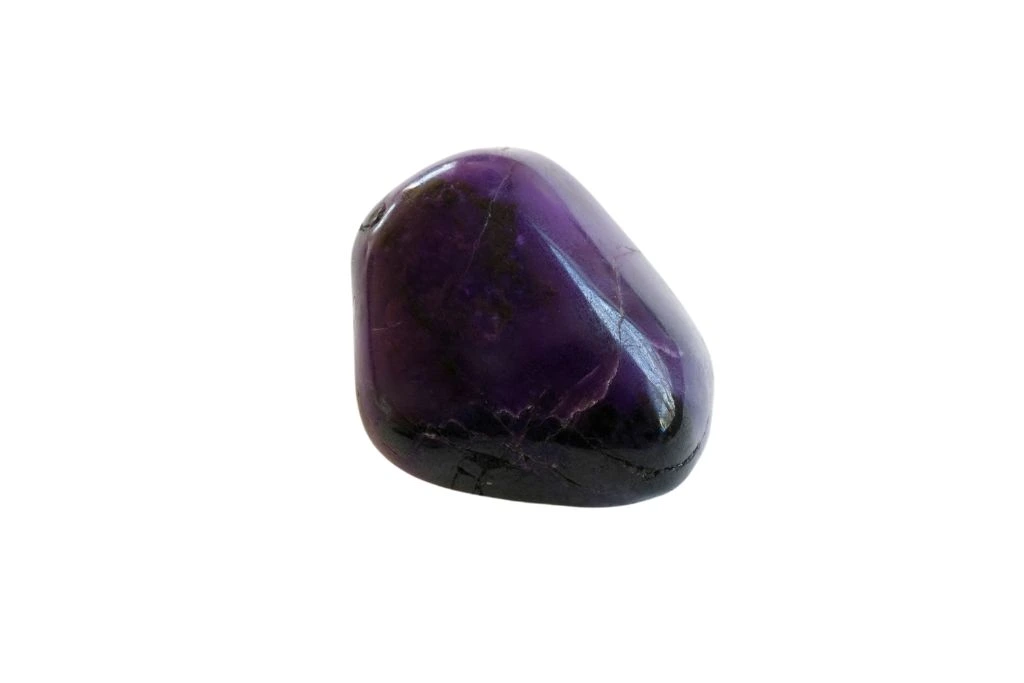 polished sugilite on a white background