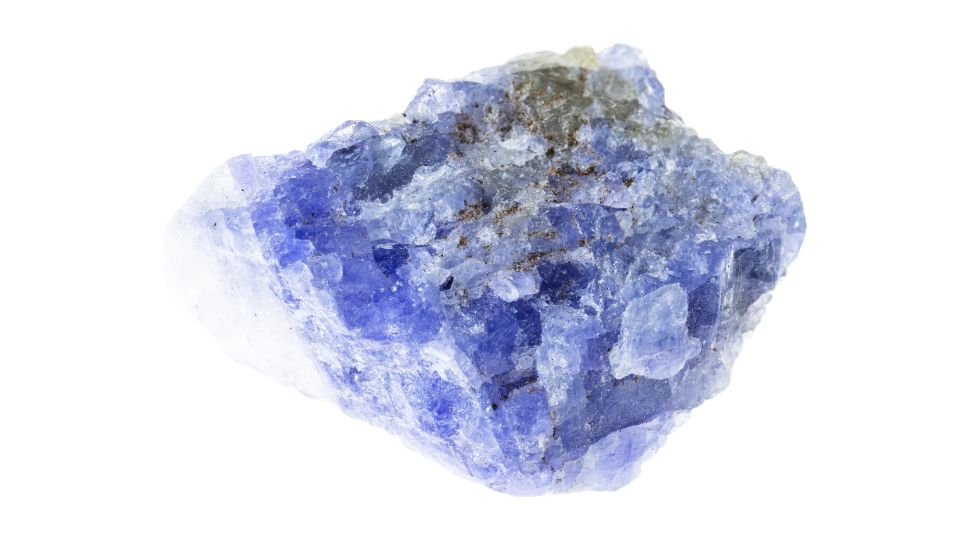 raw tanzanite crystal on a white background