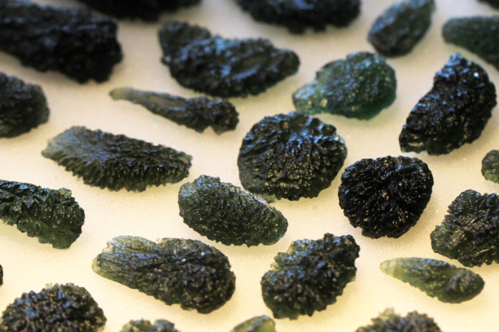 pieces of moldavite placed on top of a table