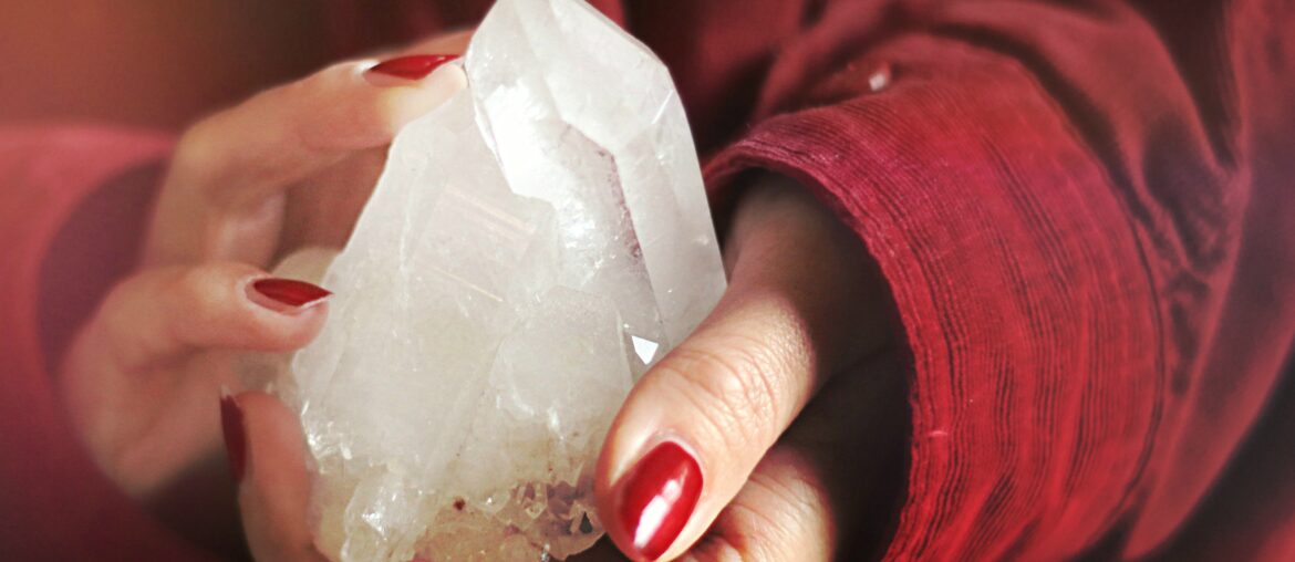 a woman holding a chunk of crystal on her hands