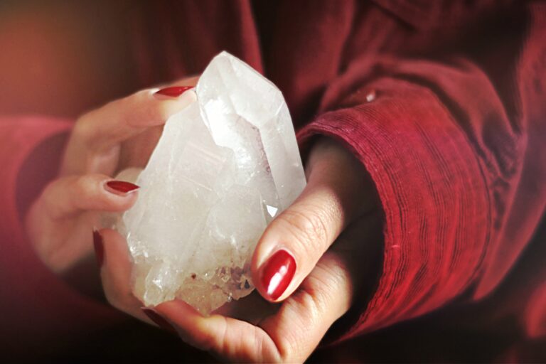 a woman holding a chunk of crystal on her hands