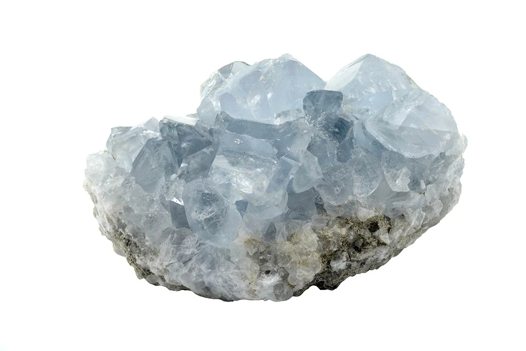 a chunk of celestite crystal on a white background
