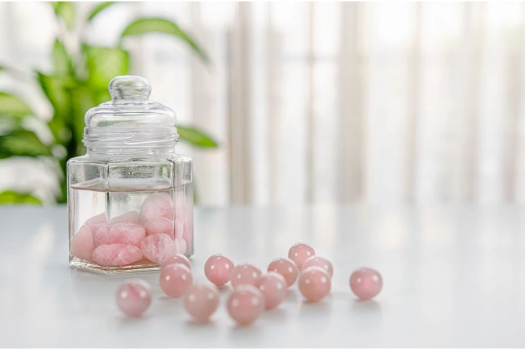 rose quartz on a jar with water