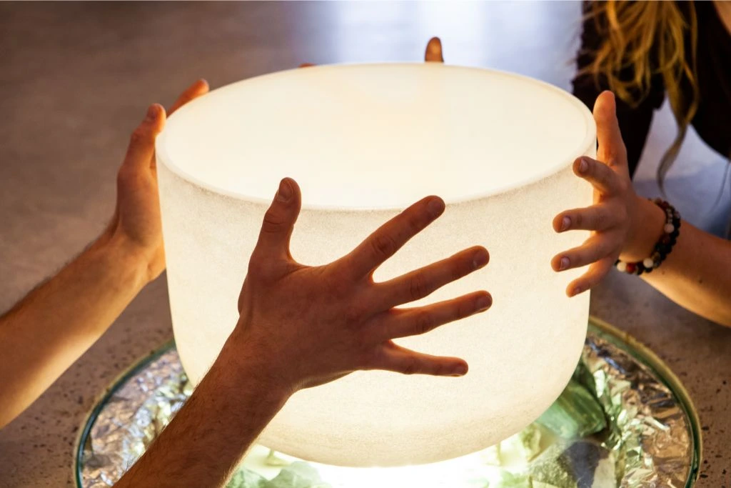 2 people holding a crystal bowl