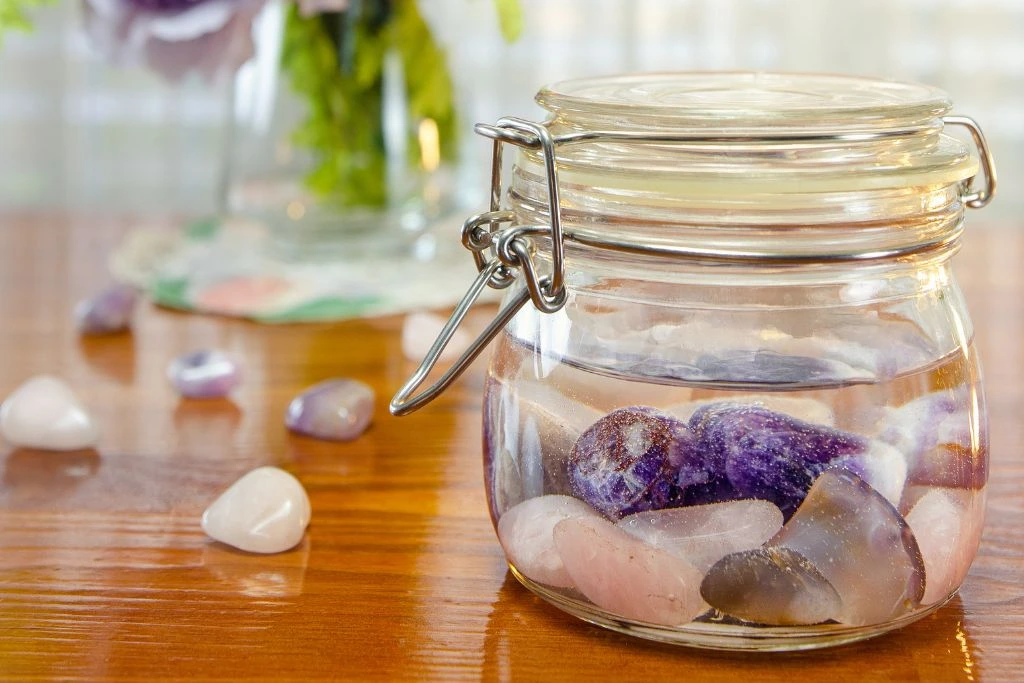 assorted crystal inside a jar of water