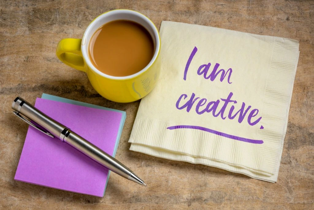 i am creative written on a piece of table napkin