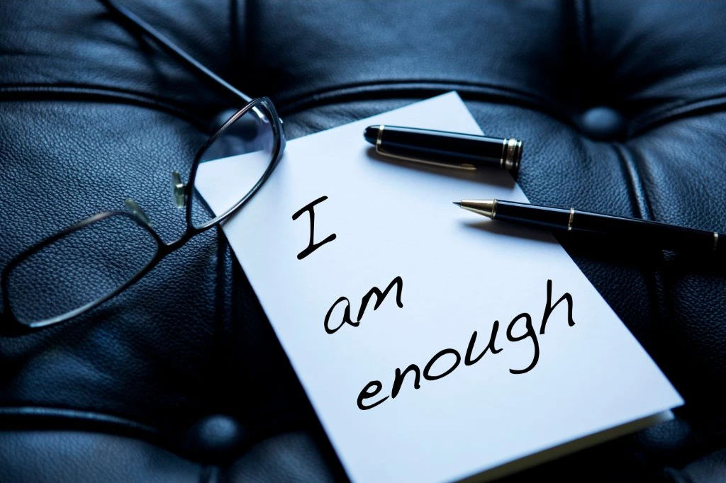 I am enough affirmation written on a piece of paper