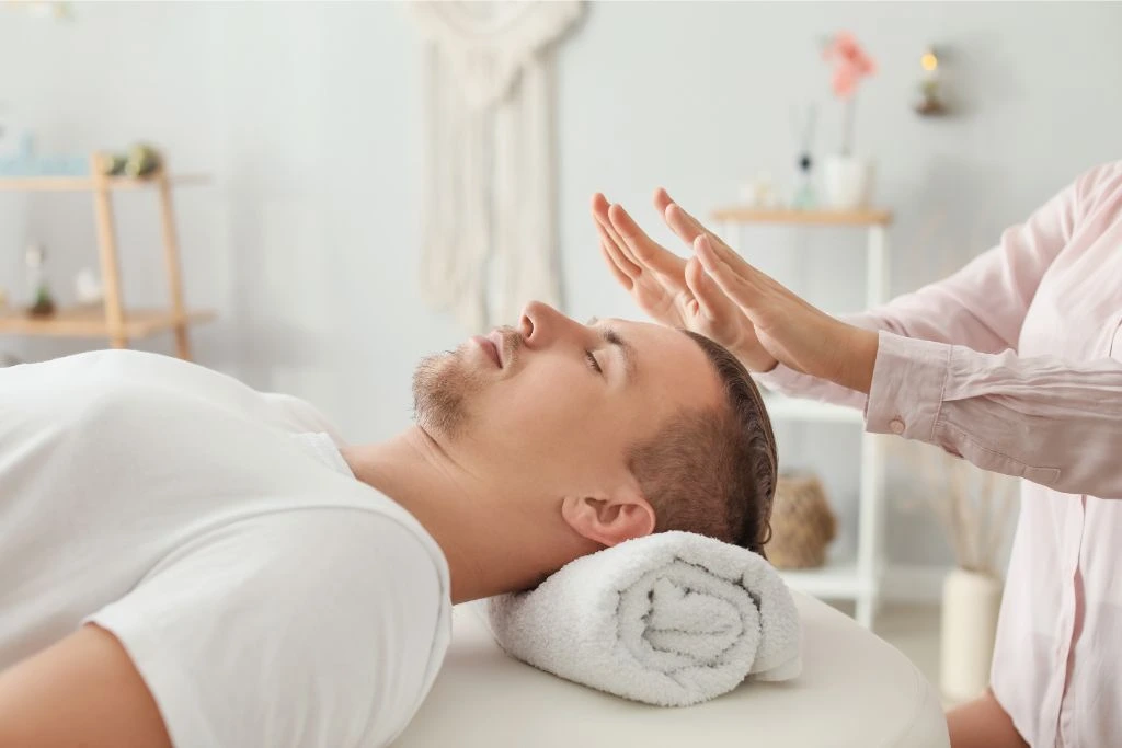 Man taking Reiki session