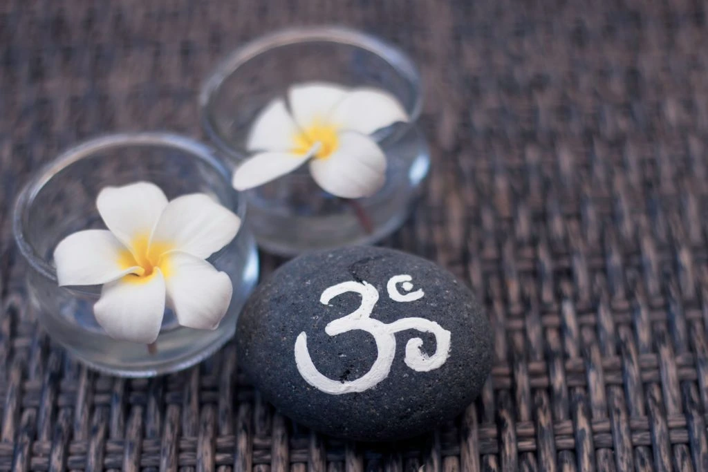 OM symbol printed on a piece of stone