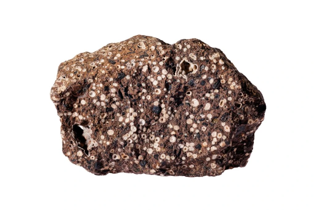 phillipsite situated on a chunk of stone on a white background