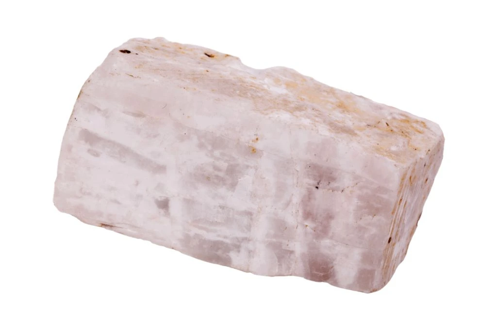 block of pink calcite for bad dreams on a white background