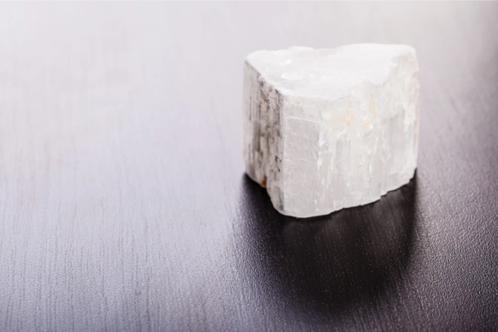 selenite stone on a wooden background