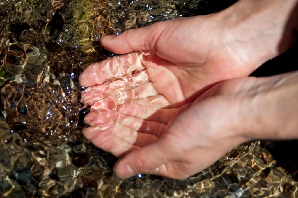 hand on a fresh running water