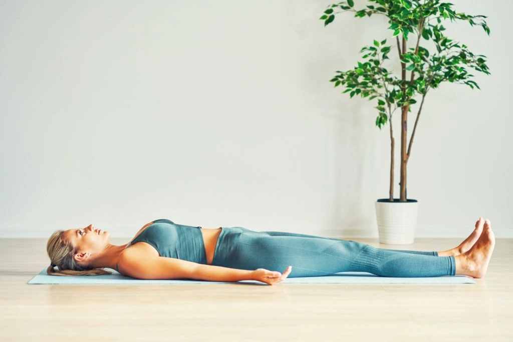 Woman Doing Yoga Laying Down on the Floor