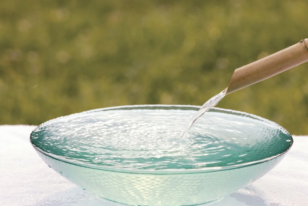 running water pouring into a clear bowl