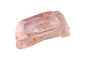 a raw kunzite crystal on a white background